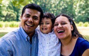 Latino,Parents,With,Their,Son,,Smiling,And,Laughing